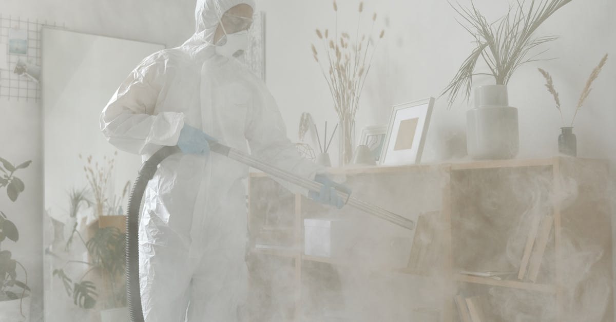 Professional pest control technician performing fumigation treatment in protective gear