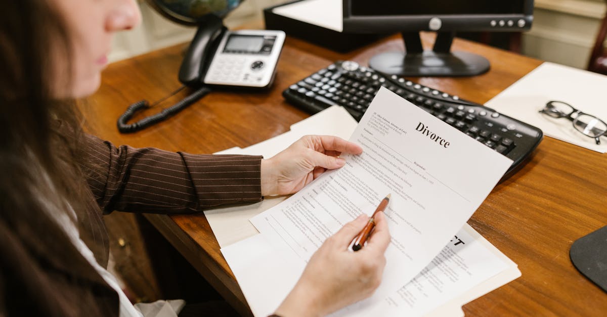 A lawyer examines divorce documents at a desk in a law office setting, emphasizing professionalism.